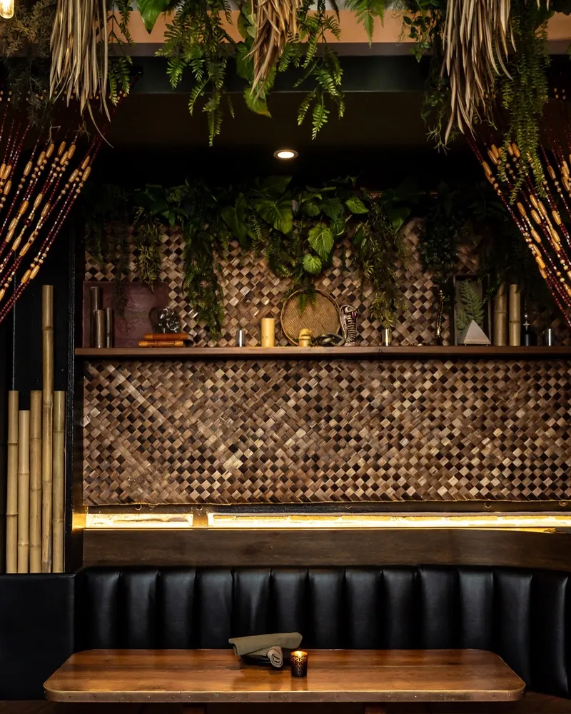 Tiki bar interior at The Lobby Oceanside — bamboo beads, tiki masks, tropical decor